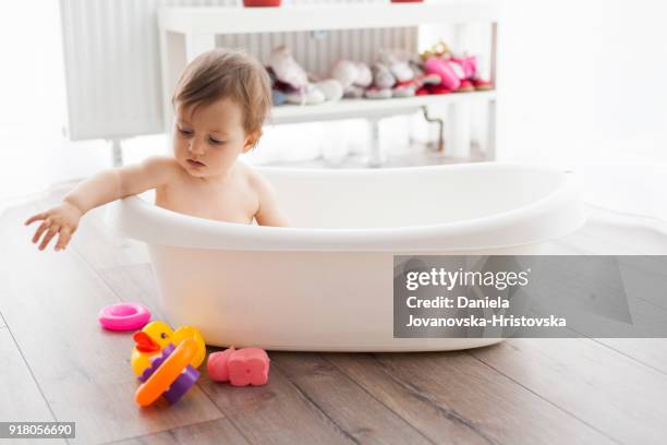 baby taking bath - baby bath toys stock pictures, royalty-free photos & images