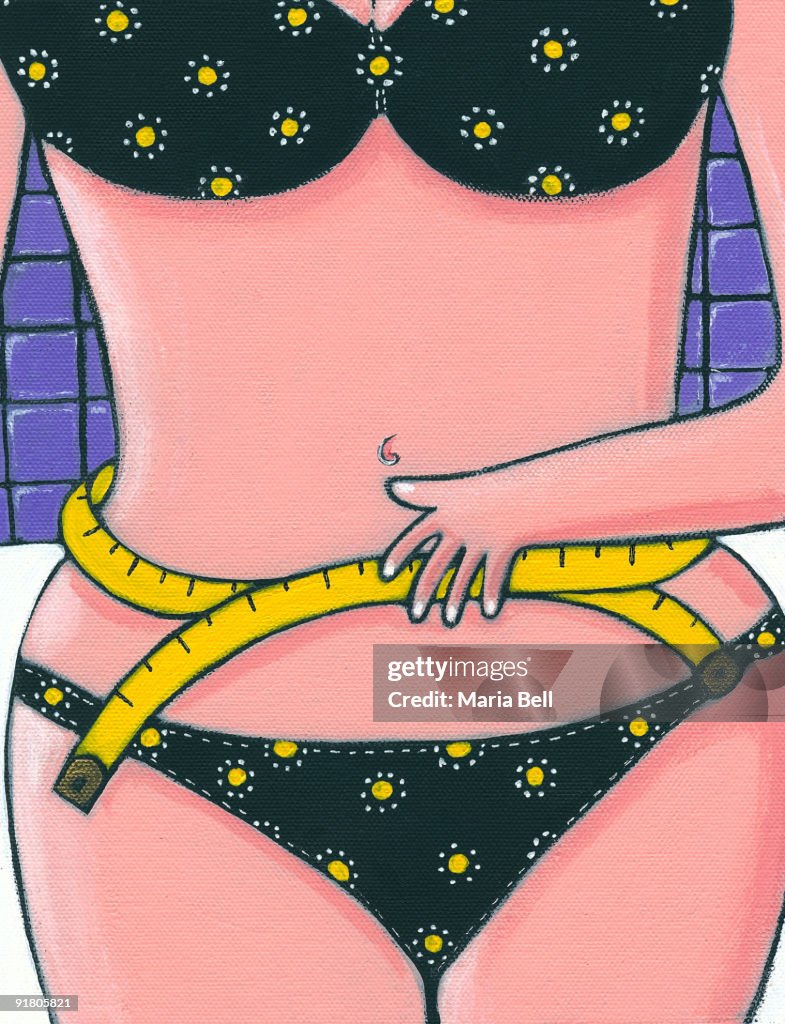 A woman measuring her waistline