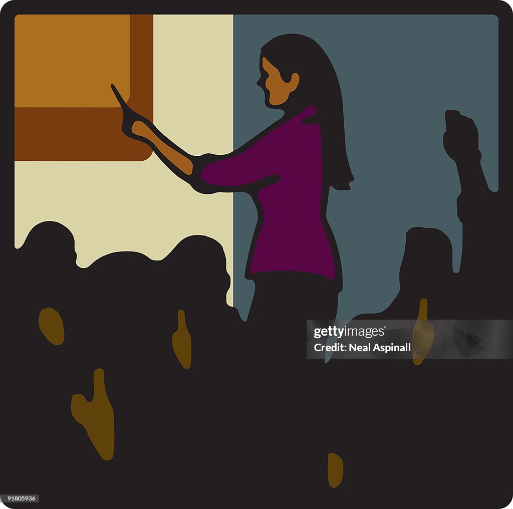 A woman pointing at a board in front of a crowd