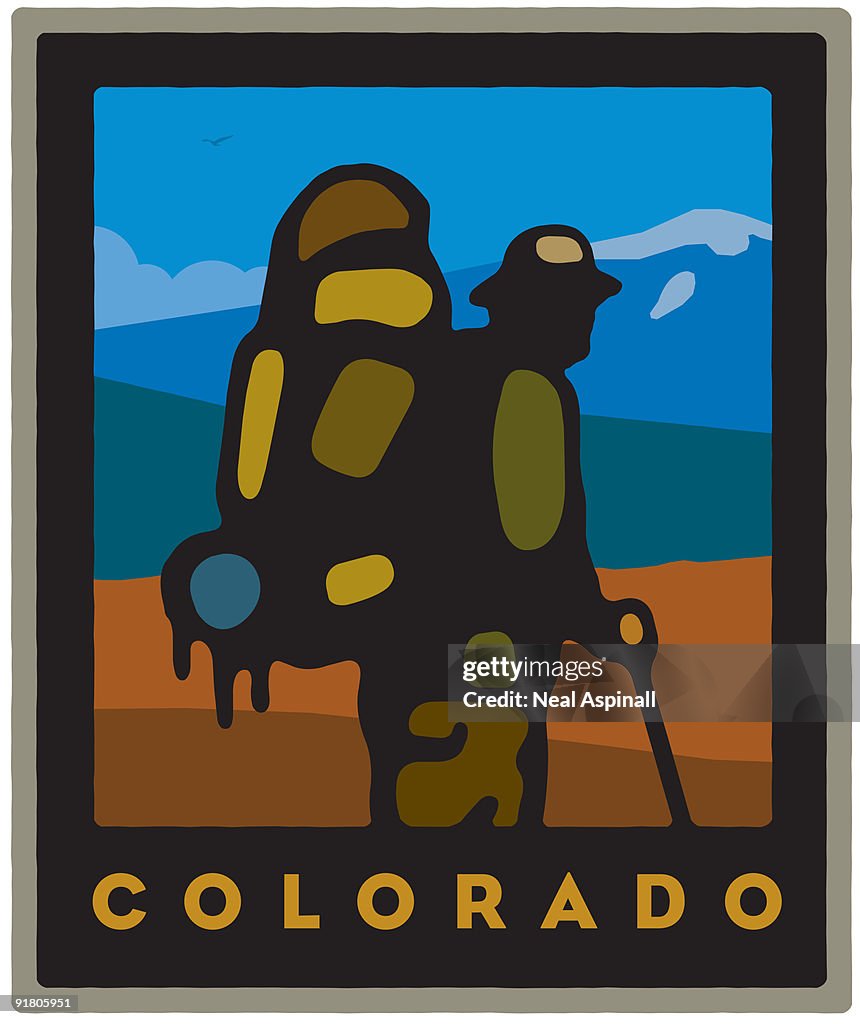 A man with a walking stick and back pack in Colorado
