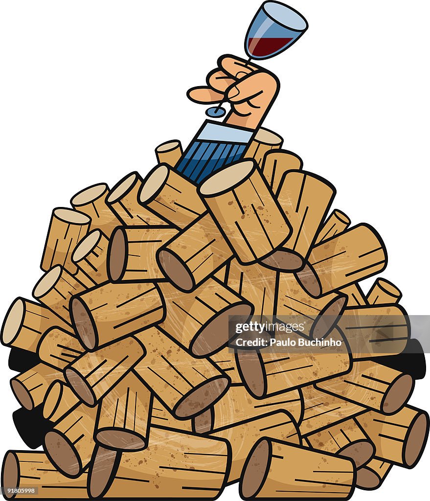 A hand holding a glass of wine from under a pile of corks