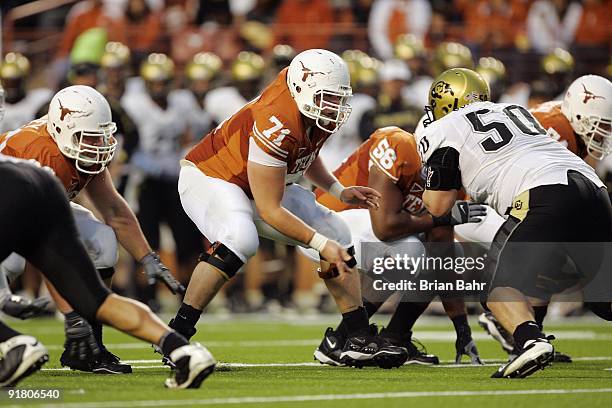 Center Chris Hall of the Texas Longhorns moves to block defensive tackle Curtis Cunningham of the Colorado Buffaloes after snapping the ball on...