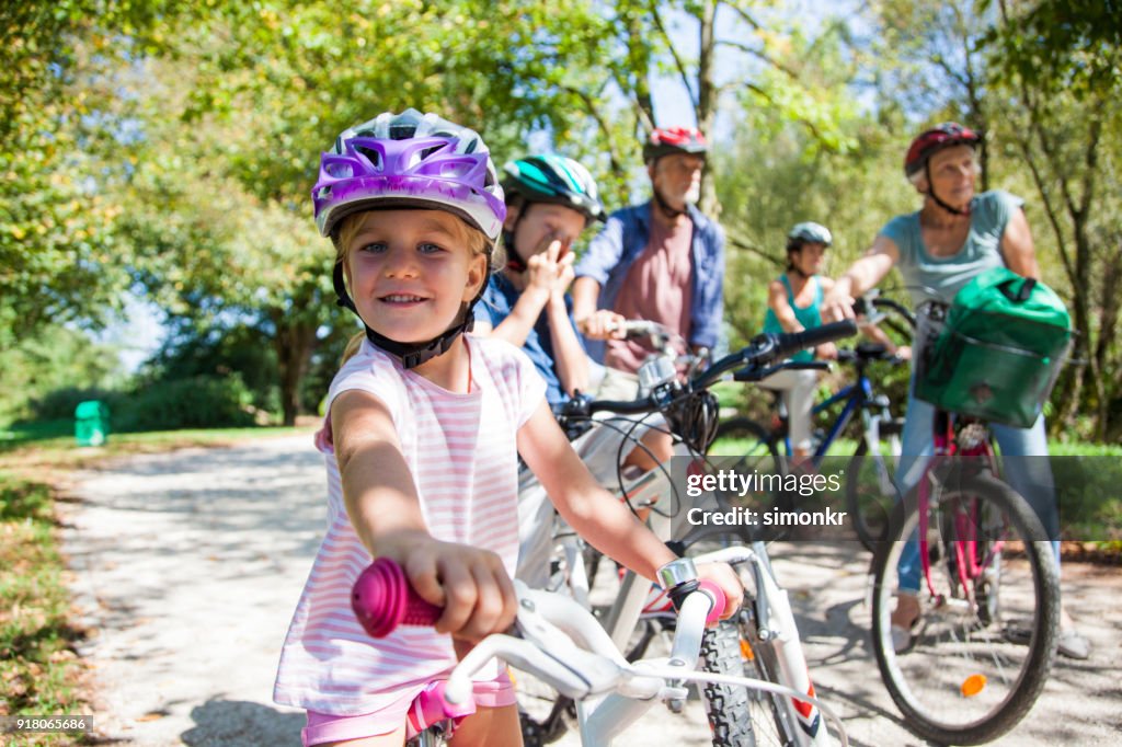 Family riding bicycle in park