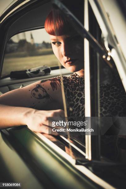 chica pin-up en el coche - pin up girl tattoo fotografías e imágenes de stock