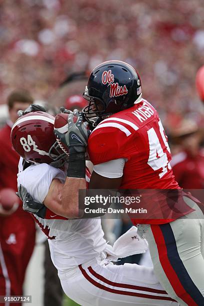 Colin Peek of the Alabama Crimson Tide hauls in a pass as Joel Kight of the Mississippi Rebels defends at Vaught-Hemingway Stadium on October 10,...