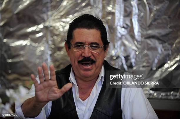 Toppled Honduran President Manuel Zelaya speaks during a meeting with advisors and negotiators inside the Brazilian embassy in Tegucigalpa, on...