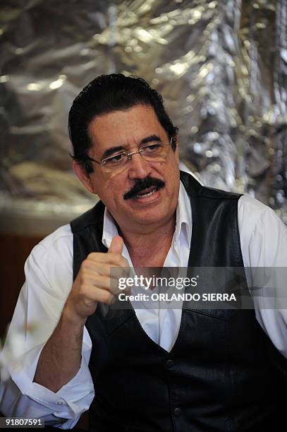 Toppled Honduran President Manuel Zelaya speaks during a meeting with advisors and negotiators inside the Brazilian embassy in Tegucigalpa, on...