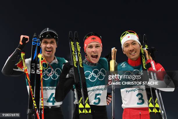 Bronze medallist Austria's Lukas Klapfer, gold medallist Germany's Eric Frenzel and silver medallist Japan's Akito Watabe celebrate at the finish...