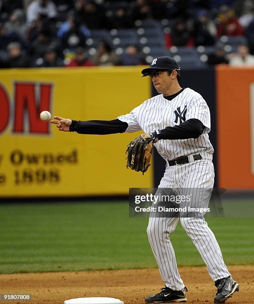 Infielder Doug Bernier of the New York Yankees throws the ball to the shortstop prior to the top of the sixth inning of an exhibition game on April...