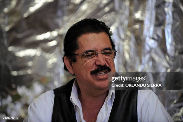 Toppled Honduran President Manuel Zelaya speaks during a meeting with advisors and negotiators inside the Brazilian embassy in Tegucigalpa, on...