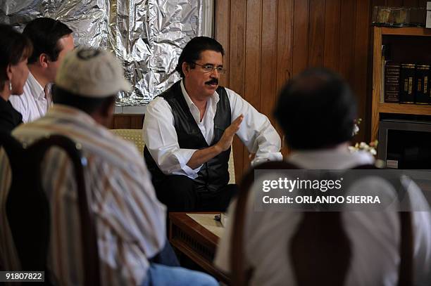 Toppled Honduran President Manuel Zelaya speaks during a meeting with advisors and negotiators inside the Brazilian embassy in Tegucigalpa, on...