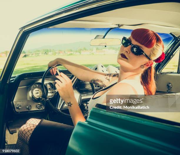 pin-up girl in a car - pin up girl tattoo stock pictures, royalty-free photos & images
