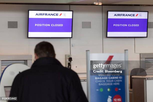 Electronic screens display 'position closed' above the Air France-KLM Group check-in area at Charles de Gaulle airport, operated by Aeroports de...