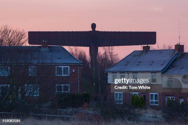 The Angel of the North is seen through nearby houses at sunrise on February 14, 2018 in Gateshead, England. Tomorrow marks the 20th anniversary since...