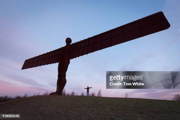 Walker poses next to the Angel of the North at sunrise on February 14, 2018 in Gateshead, England. Tomorrow marks the 20th anniversary since the...