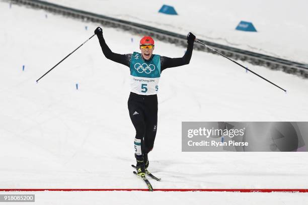 Eric Frenzel of Germany celebrates as he crosses the line to win gold during the Nordic Combined Individual Gundersen Normal Hill and 10km Cross...