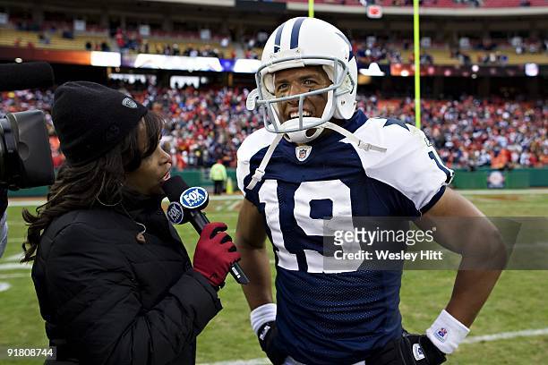 Miles Austin of the Dallas Cowboys is interviewed by FOX Sports commentator Pam Oliver after scoring the game-winning touchdown in overtime against...