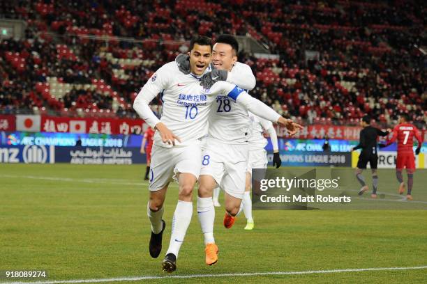 Giovanni Moreno of Shanghai Shenhua celebrates scoring the opening goal with his team mate Cao Yunding during the AFC Champions League Group H match...