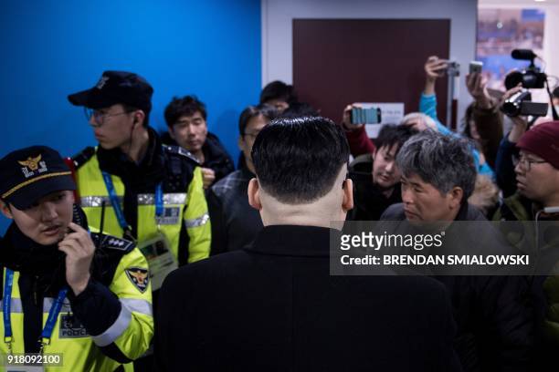 Kim Jong Un impersonator is forced out in the final period of the women's preliminary round ice hockey match between Japan and the Unified Korean...