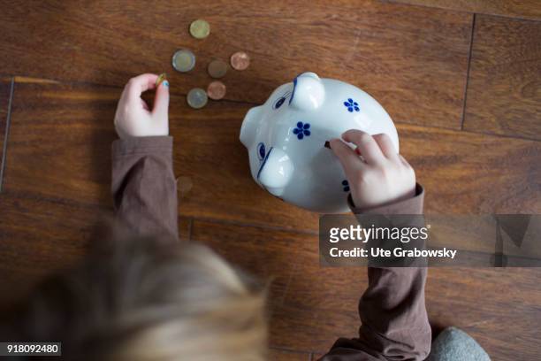 Bonn, Germany Five-year old girl puts money in a money box on February 03, 2018 in Bonn, Germany.