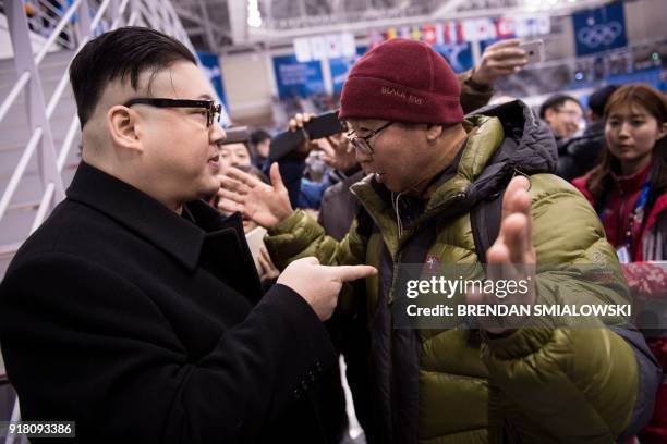 Kim Jong Un impersonator is confronted during the final period of the women's preliminary round ice hockey match between Unified Korea and Japan...