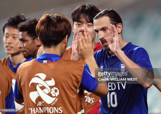 South Korea's Suwon Bluewings player Dejan Damjanovic celebrates with teammates after scoring his second goal against Australia's Sydney FC during...
