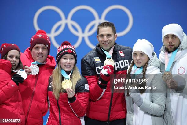 Silver medalists Jenny Perret and Martin Rios of Switzerland, gold medalists Kaitlyn Lawes and John Morris of Canada, and bronze medalists Anastasia...