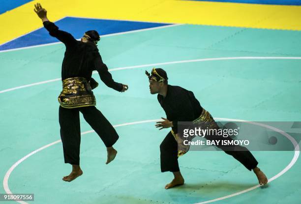 Yolla Primadona Jampil and Hendy of Indonesia perform during men's double final of Asian Games 2018 test event in Jakarta on February 14, 2018. / AFP...
