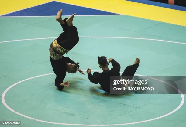 Yolla Primadona Jampil and Hendy of Indonesia perform during men's double final of Asian Games 2018 test event in Jakarta on February 14, 2018. / AFP...