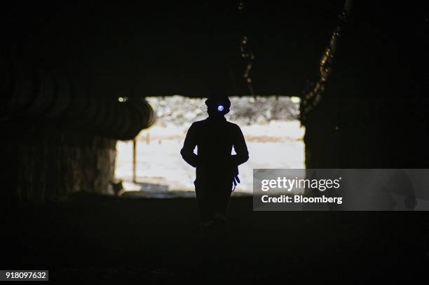 Miner walks into a mine shaft at the Northam Platinum Ltd. Booysendal platinum mine, located outside the town of Lydenburg in Mpumalanga, South...