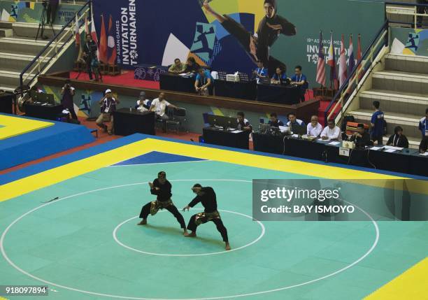 Yolla Primadona Jampil and Hendy of Indonesia perform during men's double final of Asian Games 2018 test event in Jakarta on February 14, 2018. / AFP...