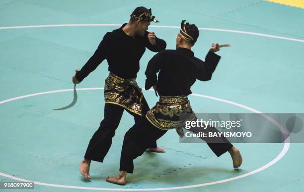 Yolla Primadona Jampil and Hendy of Indonesia perform during men's double final of Asian Games 2018 test event in Jakarta on February 14, 2018. / AFP...