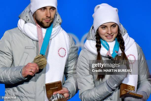 Russia's bronze medallist Anastasia Bryzgalova and Aleksandr Krushelnitckii pose on the podium during the medal ceremony for the curling mixed...