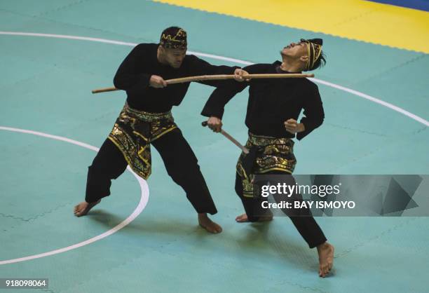 Yolla Primadona Jampil and Hendy of Indonesia perform during men's double final of Asian Games 2018 test event in Jakarta on February 14, 2018. / AFP...