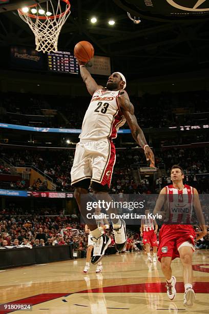 LeBron James of the Cleveland Cavaliers rises up for the fast break dunk trailed by Theodoros Papaloukas of the Olympiacos Piraeus during an NBA...