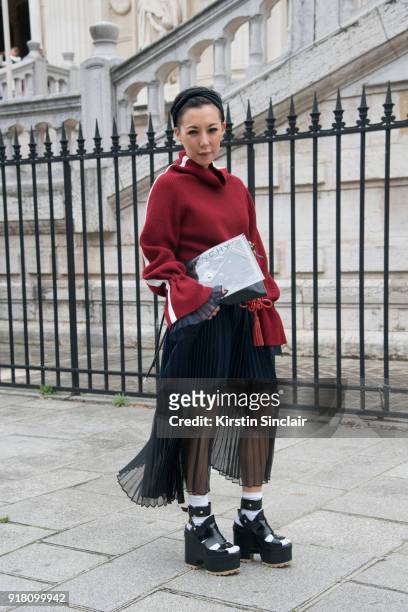 Buying Manager at Selfridges Jeannie Lee wears a Sacai skirt and sweater dress and shoes and a Balenciaga bag day 6 of Paris Womens Fashion Week...