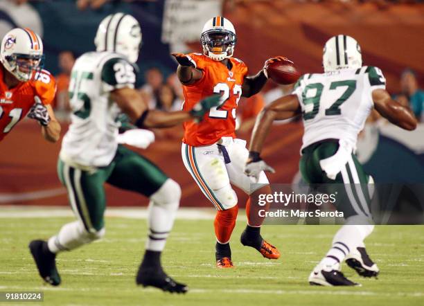 Running back Ronnie Brown of the Miami Dolphins passes the ball against the New York Jets fans prior to their game at Land Shark Stadium on October...