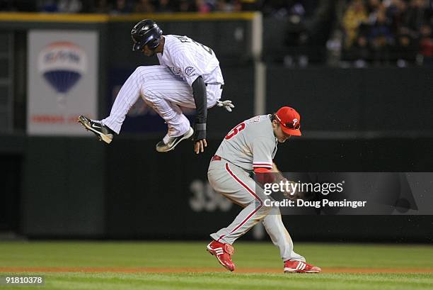 Dexter Fowler of the Colorado Rockies hurdles safely over Chase Utley the Philadelphia Phillies in Game Four of the NLDS during the 2009 MLB Playoffs...