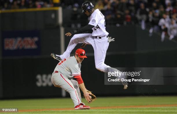 Dexter Fowler of the Colorado Rockies hurdles safely over Chase Utley the Philadelphia Phillies in Game Four of the NLDS during the 2009 MLB Playoffs...
