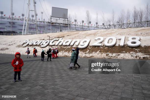 People walks past the Pyeonchang 2018 giant signage near the Olympic Stadium at the Winter Olympic Park during the 2018 Pyeongchang Winter Olympic...