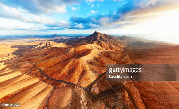 sunset over desert landscape of fuerteventura, canary islands - canary islands stock pictures, royalty-free photos & images