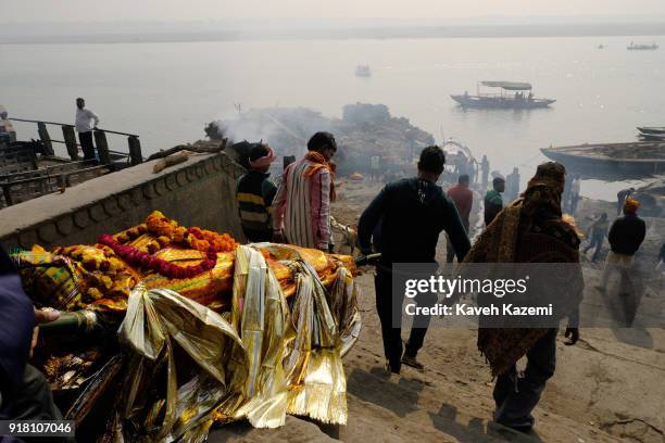Relatives of a deceased man carry his body to the cremation site in Manikarnika Ghat on January 28, 2018 in Varanasi, India. Manikarnika Ghat is one...