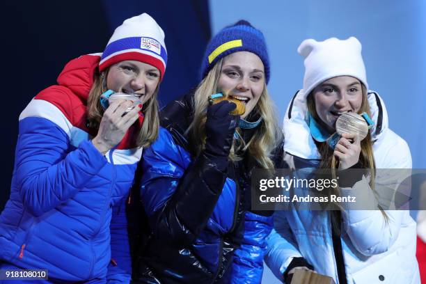 Silver medalist Maiken Caspersen Falla of Norway, gold medalist Stina Nilsson of Sweden and bronze medalist Yulia Belorukova of Olympic Athlete from...