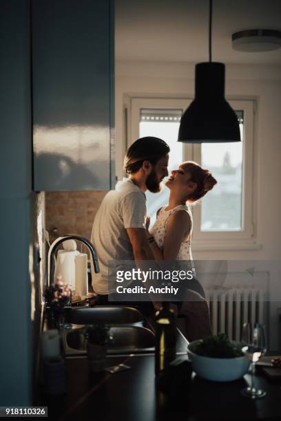 romantische paar in de keuken - flirting stockfoto's en -beelden
