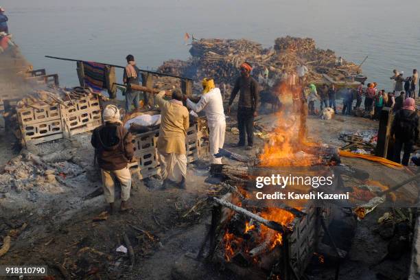 Body is laid on pyre while another burns during cremation in Manikarnika Ghat on January 28, 2018 in Varanasi, India. Manikarnika Ghat is one of the...