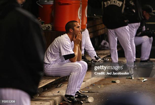 Huston Street of the Colorado Rockies sits dejected in the dugout after the loss against the Philadelphia Phillies in Game Four of the NLDS during...
