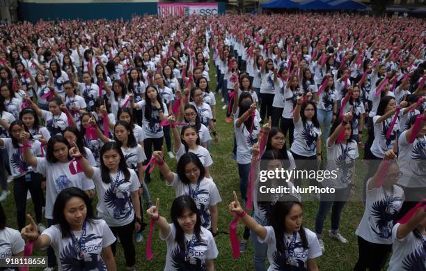 Students and faculty of St. Scholastica's College raise their fingers during the annual global event dubbed the One Billion Rising held at St....