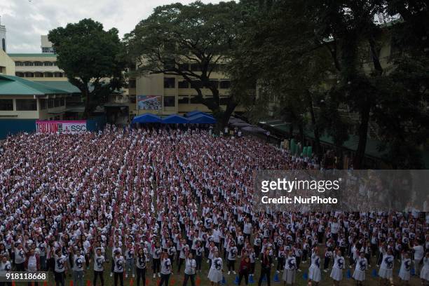 Students and faculty of St. Scholastica's College raise their fingers during the annual global event dubbed the One Billion Rising held at St....