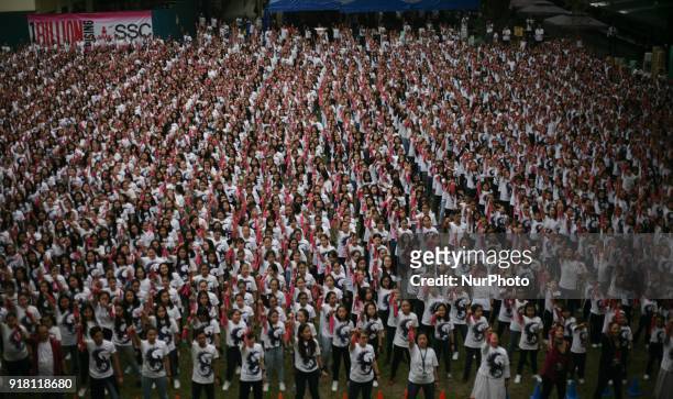 Students and faculty of St. Scholastica's College raise their fingers during the annual global event dubbed the One Billion Rising held at St....