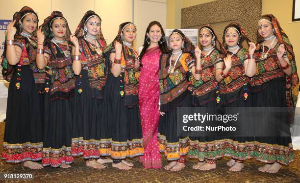 Indian girls representing the state of Rajasthan pose for a photo with their teacher before competing in a traditional Indian folk dance competition...